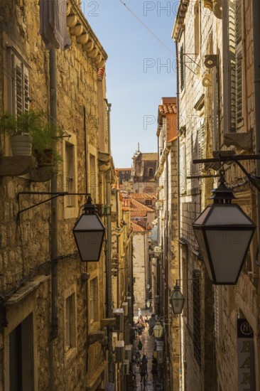 High angle view of narrow street with tourists and visitors in old walled city of Dubrovnik,