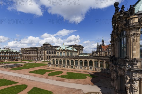 The Zwinger Palace in Dresden, Germany, showcases its stunning baroque architecture under a vibrant