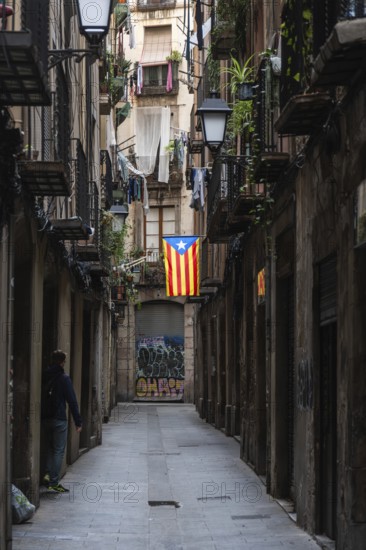 A flag of the Estelada of the Catalan Nationalists in an alley of the historic centre of Barcelona,