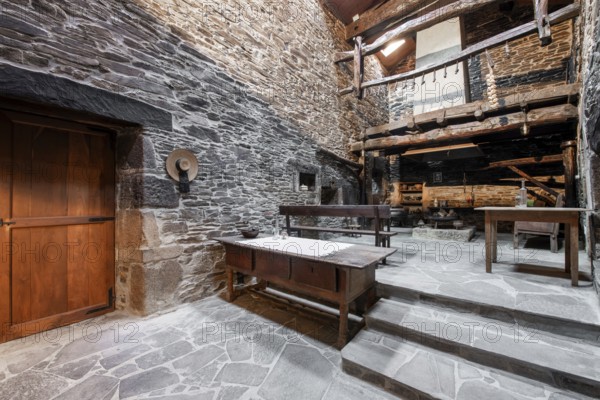 An authentic rustic kitchen featuring stone walls and wooden beams in a historical country house in