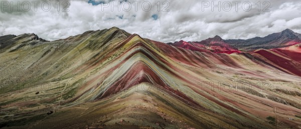 A stunning panoramic capture of Vinicunca, or Rainbow Mountain, famous in Peru for its colorful,
