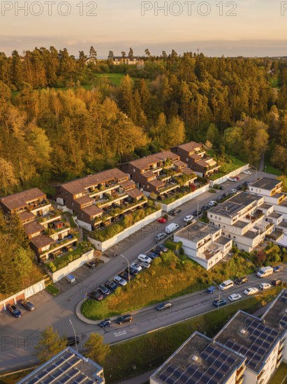 Terraced houses and residential buildings along a road, embedded in a wooded landscape, Nagold,