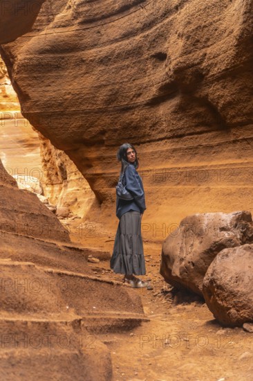 Tourist walking through the unique rock formations of barranco de las vacas, a stunning canyon in