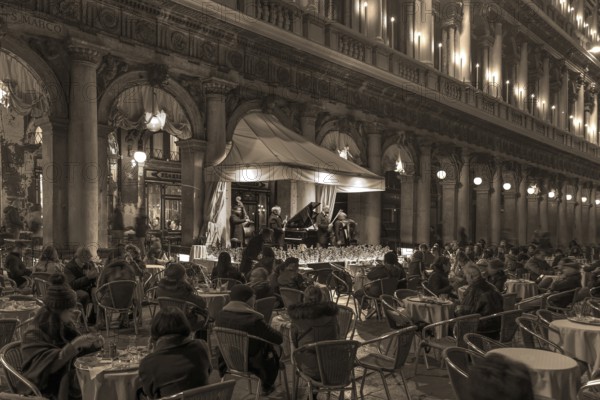 Music orchestra playing in front of the historic Café Florian on St. Mark's Square in the evening,