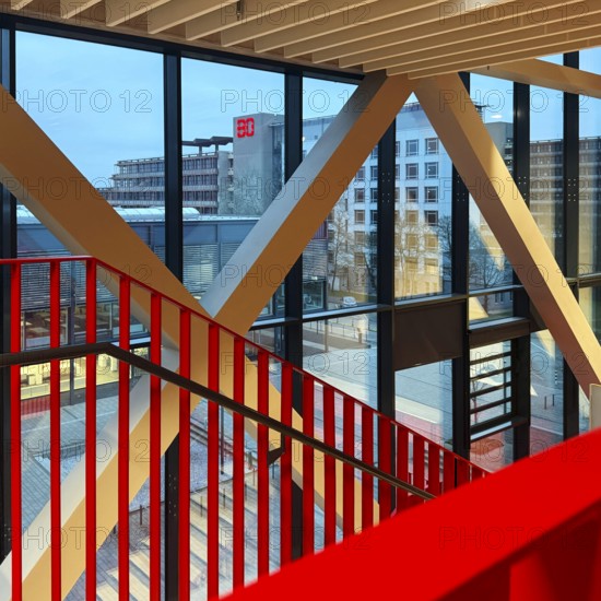 Staircase with signal red color scheme in seminar building H of Bochum University in the evening