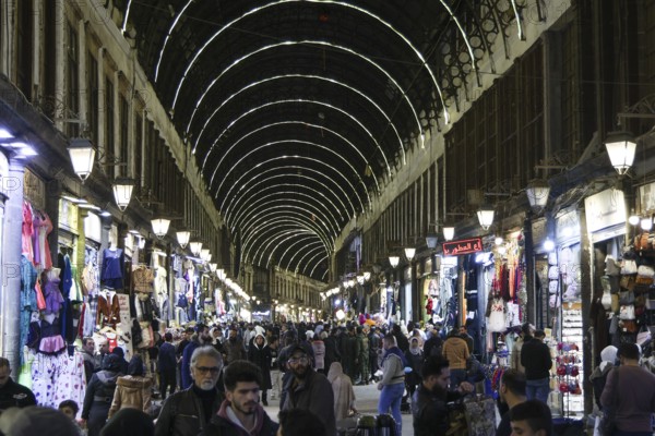 Syrians shop at the historic Al-Hamidiyah Bazaar adjacent to the Umayyad Mosque during the early