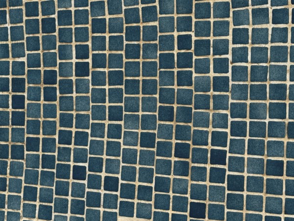 A close-up of a surface adorned with small, blue square tiles arranged in a geometric pattern. The