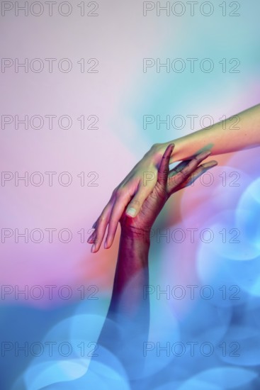 A close-up image of two multiethnic hands reaching towards each other in a gesture of unity and