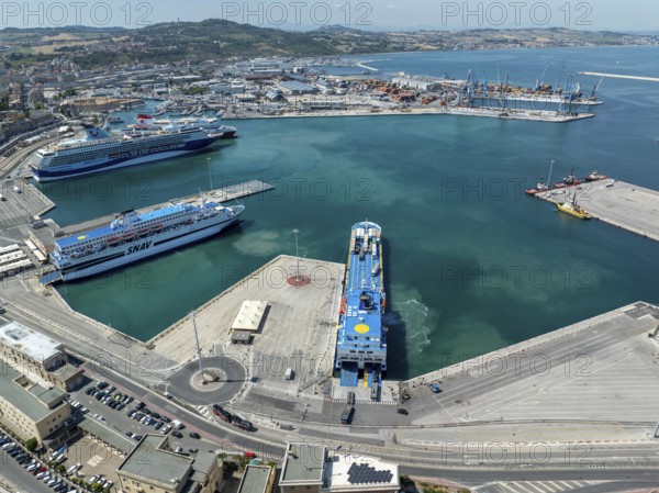 Aerial view of Ancona harbor, Italy, showcasing cruise ships docked at the port, surrounded by