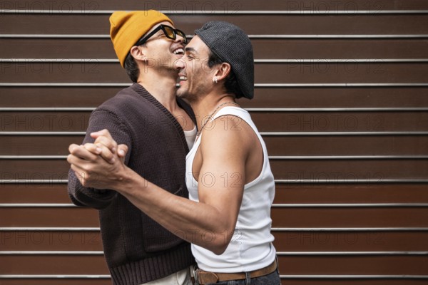 A joyful couple dances and smiles, capturing a moment of happiness and love. They wear casual