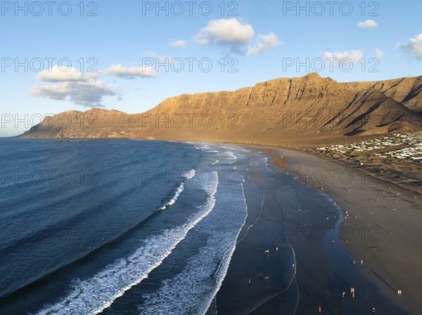 Risco de Famara cliffs and sea with Famara beach, in the evening light, Playa de Famara, aerial