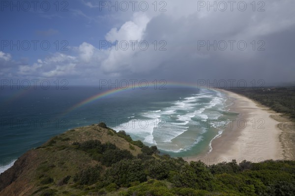 Tallow Beach bay with rainbow, lookout Byron Bay lighthouse, New South Wales, Australia
