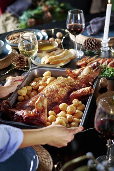 Cropped unrecognizable woman's hands serving a roasted suckling pig accompanied by potatoes,