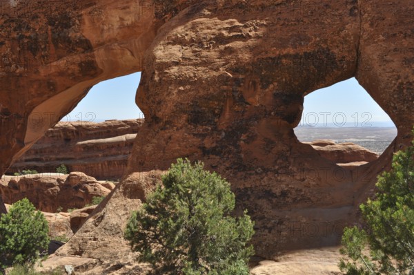 Sandstone formations with double windows offer spectacular views of the desert, Arches National
