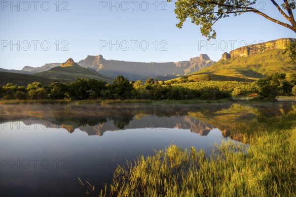 Sunrise, amphitheatre with reflection in the lake, Royal Natal National Park, Drakensberg Mountains