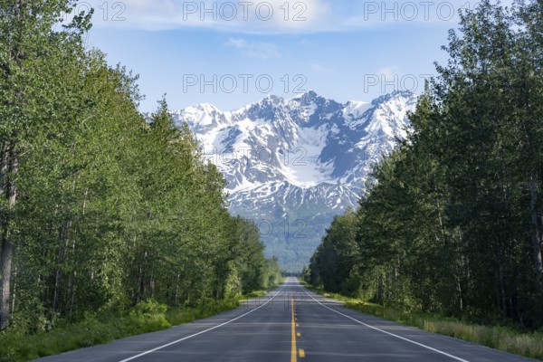 Road through taiga and mountainous landscape, picturesque landscape on Richardson Highway, Alaska,