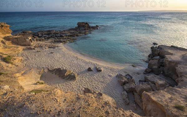 A tranquil beauty of Calo des Mort, Spain, featuring pristine sand and inviting turquoise waters,