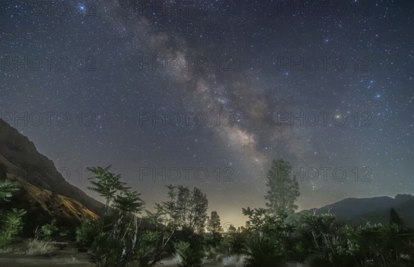 A breathtaking view of the Milky Way galaxy stretching above the serene landscape of Sequoia