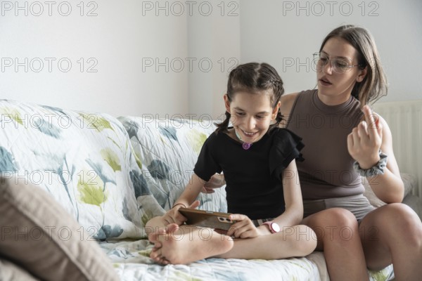 A joyful family scene featuring a young cheerful girl with a tracheostomy, sharing a tender moment