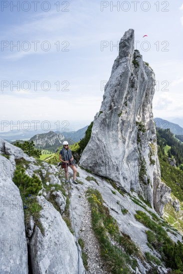 Climber with climbing rope on a climbing tour, climber on a mountain ridge, pointed rock peak,