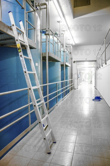 Long corridor with blue walls and a ladder on the side, ENCW Netze Calw waterworks, Calw, Black