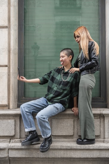 A Colombian lesbian couple enjoys a day out, capturing joyful moments together. Embracing love,