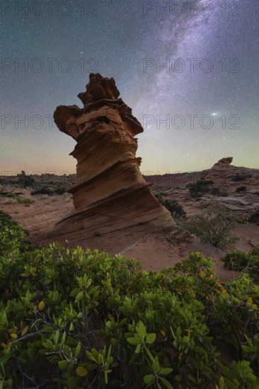 A stunning rock formation stands tall against a backdrop of a starry night sky in Coyote Buttes,