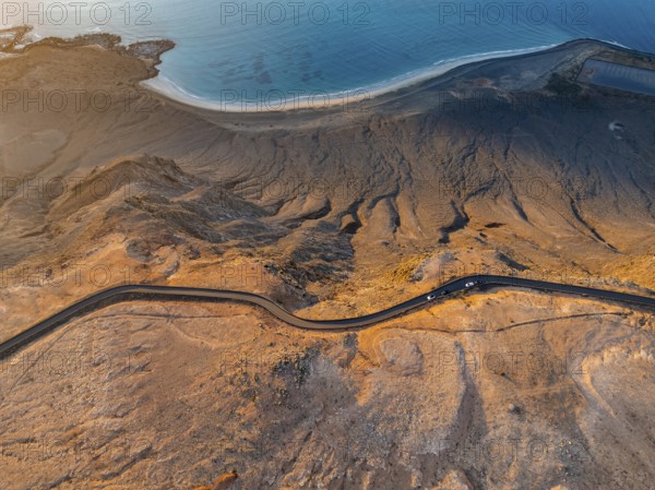 Road on cliffs in evening light, steep cliffs on the coast near Mirador del Porrito, aerial view,