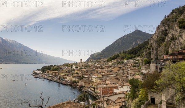 A picturesque view of Limone Sul Garda, Italy, nestled between Lake Garda and steep mountains The