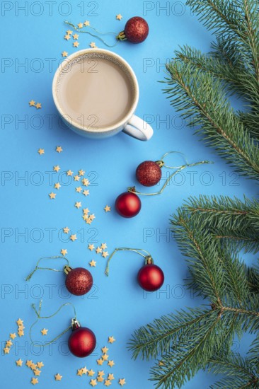 Christmas or New Year composition. Decorations, red balls, fir and spruce branches, cup of coffee,