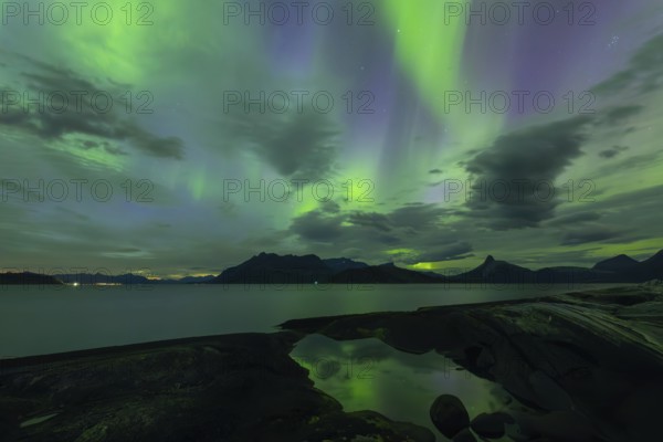 Northern lights at dawn over Sørfolda Fjord near Kjerringøy between Bodø and Sørfold in Norway