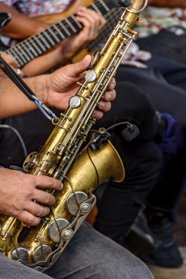 Saxophonist and other instrumentalists playing on the streets of the city of Recife, Recife,