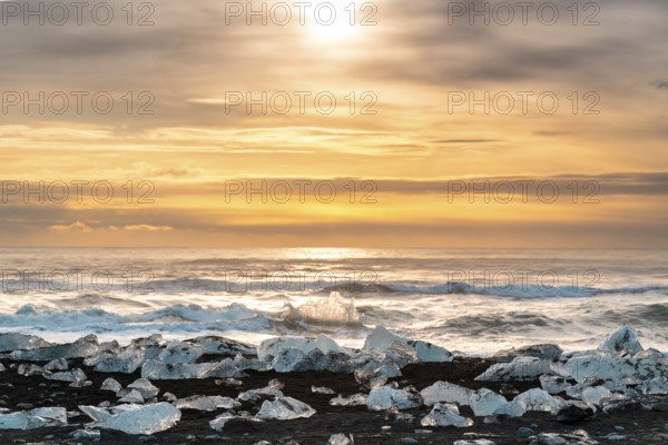 Captivating sunrise over Diamond Beach, Iceland, with ice fragments glistening on black sands and