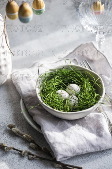 A fresh Easter setting featuring painted eggs tucked delicately within lush green grass, arranged