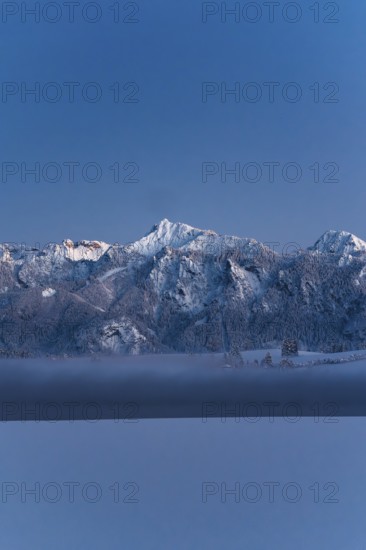 Shortly after sunset, twilight at Lake Hopfensee in the Allgäu in Bavaria in a winter landscape,