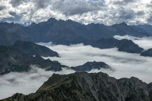 View from the Nebelhorn summit to mountains of the Allgäu Alps, mountains rising from fog in the