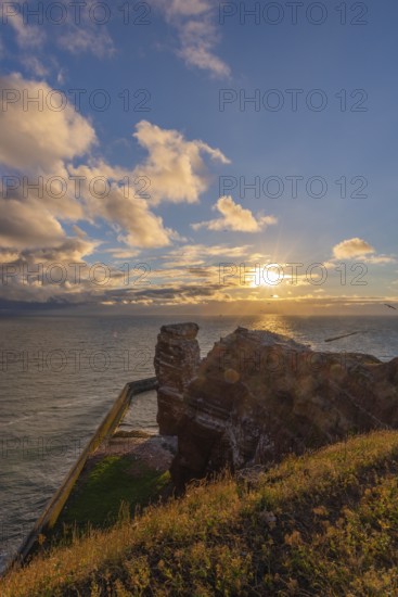 Red red sandstone cliff edge, Heligoland high sea island, Lange Anna, backlight, North Sea, blue