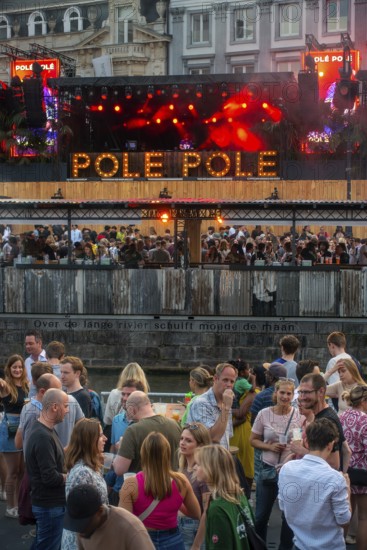 Spectators on grandstand at the Graslei watching Pole Pole podium during Gentse Feesten, Ghent city