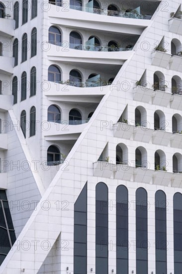 A striking modern building features geometric patterns and arches, located in Georgia. The white