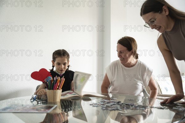 A joyful family moment with a girl with a tracheostomy engaging in art and puzzles, surrounded by