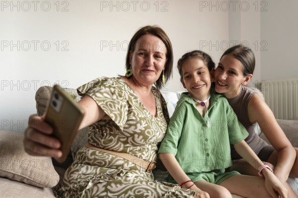 A family enjoying quality time together. A young girl with a tracheostomy smiles warmly with her