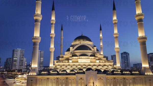 Aerial view captures hundreds of Muslims gathered at long tables for a communal Iftar meal in a