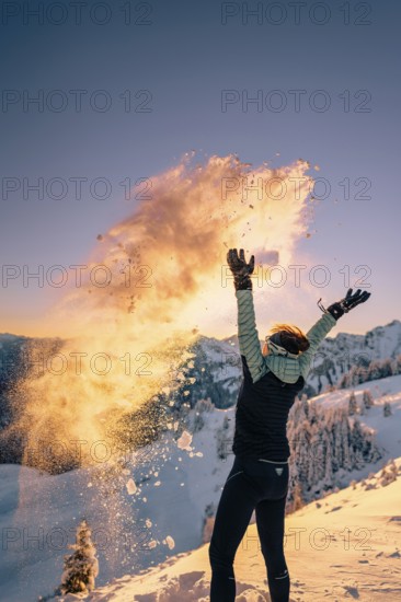 Summit bliss in the snow-covered winter landscape in the Tannheimer Tal in the Alps on the