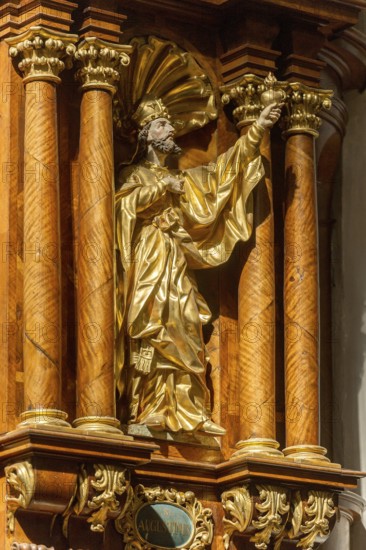 Carved wooden figure of St Augustine on the pulpit of the parish church of the Assumption of the