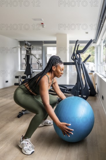 Businesswoman maintaining her workout routine while traveling, performing squats with a fitness