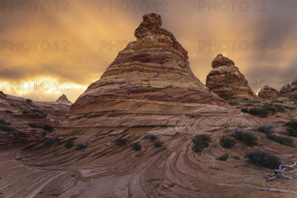 Vibrant sunset illuminates the swirling sandstone formations of Coyote Buttes in the Paria