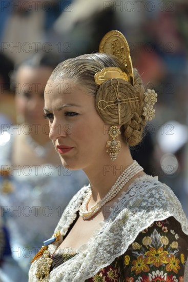 Fallas festival, woman in a traditional costume during the parade in the Plaza de la Virgen de los