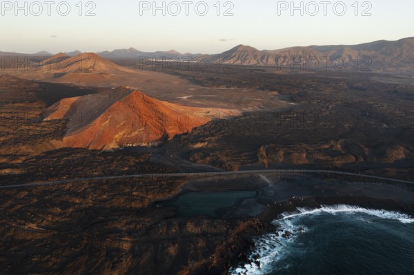 Aerial shot showcasing the stunning juxtaposition of Timanfaya national park and Los Hervideros