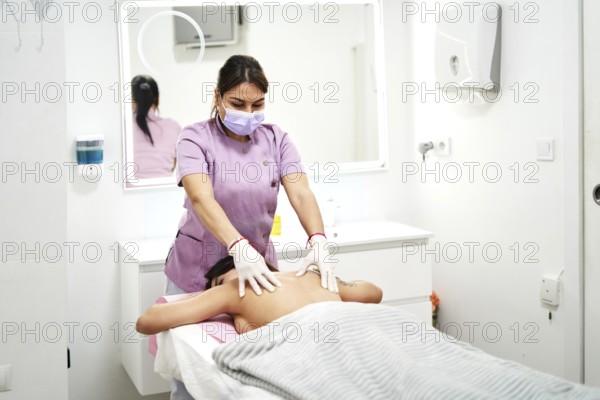 Skilled therapist provides a relaxing massage to a client at a professional beauty salon. The