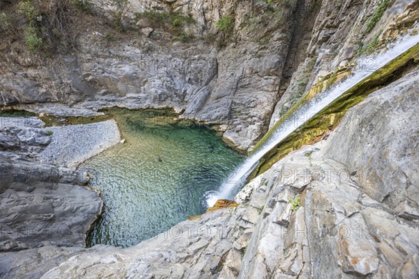 A breathtaking view of a canyon with crystal-clear waters, perfect for adventure seekers enjoying